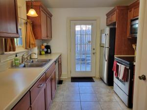 a kitchen with a sink and a refrigerator at The Grand BnB in Harrisburg