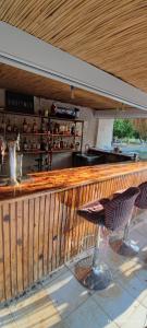 a wooden bar with a table and a chair at ORANGE BEACH CAMP in Beldibi