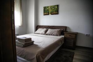 a bedroom with a bed with towels on it at Lena_Lux in Jagodina +35 photos