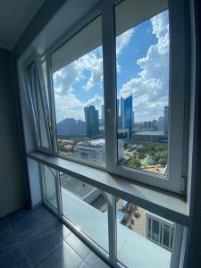 a view of a city from a window in a building at Luxury apartment Atlant in Astana