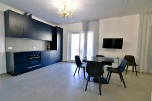 a living room with a dining room table and chairs at Palazzo Mosillo in Sperlonga
