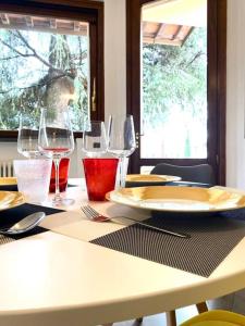 a table with wine glasses and plates on it at Casa BelMoro con piscina in Pescia
