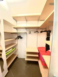 a walk in closet with shelves and a red table at Casa BelMoro con piscina in Pescia
