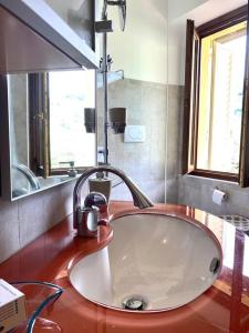 a sink with a faucet on a counter in a bathroom at Casa BelMoro con piscina in Pescia