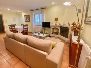 a living room with a couch and a fireplace at Casa Outeiro in Betanzos