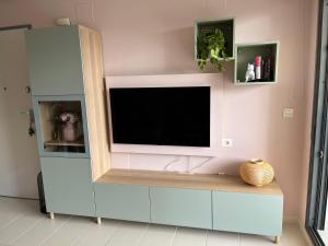 a living room with a tv on a wall at Appartement Punta Prima in Torrevieja
