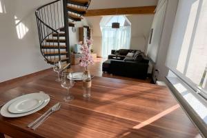 a dining room table with plates and wine glasses on it at Shine Apartment Wackersdorf II in Wackersdorf