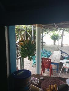 a large bunch of bananas hanging from a porch at sunrise seasports in Iboih