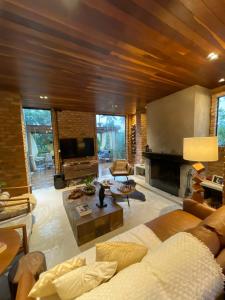 a living room with a couch and a fireplace at Casa da Pedra Serrinha in Resende