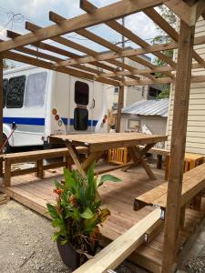 a picnic table on a deck with a trailer at Maryland Homestay in Winnpeg downtown in Winnipeg