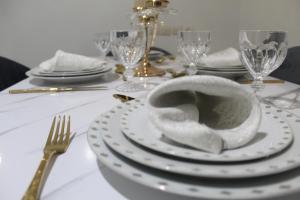 a table with a white plate with a bowl on it at Yassers Residence in Er Rachidia
