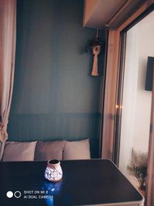 a table with a vase on it in a room at Le Front de Mer, superbe vue mer in Saint-Jean-de-Monts