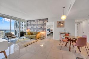 a living room and dining room with a table and chairs at Icon Luxury 34th Floor Amazing Oceanview, Brickell in Miami