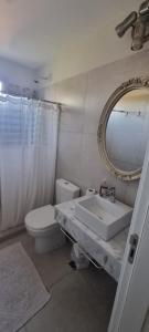 a bathroom with a sink and a toilet and a mirror at Nuevo apartamento zona aeropuerto in Luque +11 photos