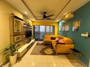 a living room with a couch and a tv at Aqilla Homestay in Kuala Selangor