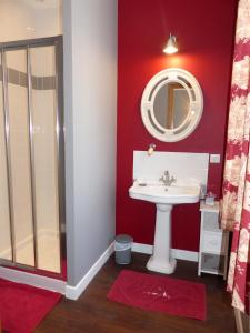 a bathroom with a sink and a mirror at La Cour des Carmes in Arras