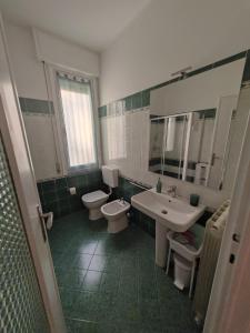 a bathroom with two toilets and a sink and mirror at La Casa di Gi&Vi in Sanremo +34 photos