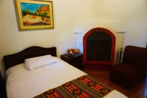 En eller flere senger på et rom på Hacienda Hosteria San Luis