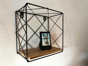 a clock on a shelf on a wall at Casa del Burro Perezoso in Almáchar