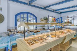 a restaurant with a buffet of food on display at Sergiani Garden Hotel Apartments in Stalís