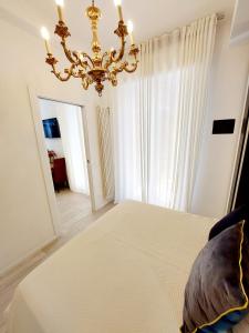 a bedroom with a large bed with a chandelier at Piccolo Mondo Verona in Verona