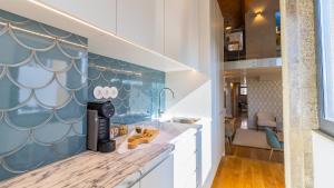 a kitchen with blue and white wall paper at Downtown PortoEdition in Porto +164 photos