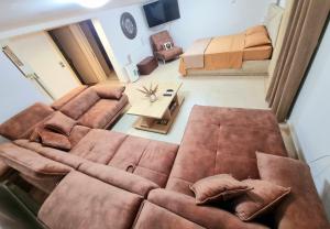 a living room with a couch and a bed at Cozy apartment near sea and airport in Artemida