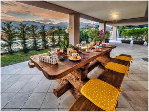 a wooden table and chairs on a patio at Villa TaDi LaRo Luxury Relax Comer See Colico in Carriola