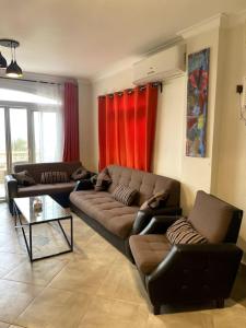 a living room with a couch and a coffee table at Spacious Penthouse Chalet at Telal Sokhna in Ain Sokhna