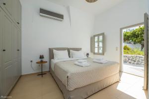 a bedroom with a bed with towels on it at Dolphin Estate 1868 in Megalokhori +22 photos