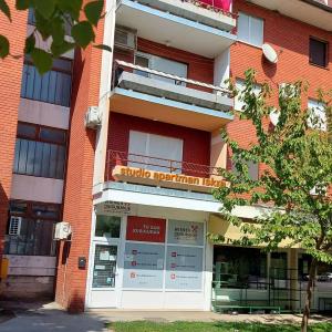 a brick building with a sign on it at Studio apartman Iskra, self check IN-OUT in Županja