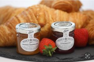 two jars of jam next to strawberries and croissants at 99 at Lynian Farm in Blackpool