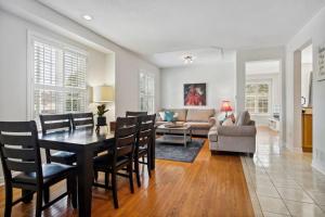 a living room with a table and chairs and a couch at The cozy corner House in the Richmond Hill in Richmond Hill