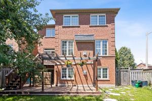 a brick house with a fence in front of it at The cozy corner House in the Richmond Hill in Richmond Hill