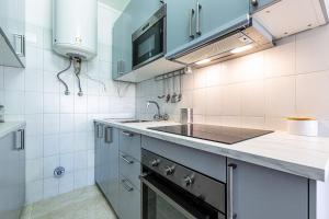a kitchen with a sink and a stove top oven at Beachside Bliss in Armação de Pêra