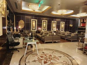 een woonkamer met banken en een tafel en stoelen bij Province Al Sham Hotel in Al Madinah