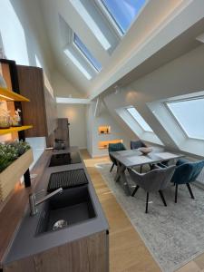 a kitchen with a sink and a table at SUITE WARTBURGBLICK direkt am Bahnhof in Eisenach