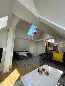 a living room with a couch and a pool table at SUITE WARTBURGBLICK direkt am Bahnhof in Eisenach