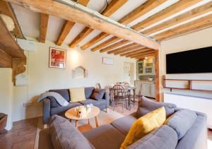 a living room with two couches and a table at 1 New Thatched Cottage in Edingthorpe