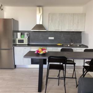 a kitchen with a table with a bowl of fruit on it at ROXY HOME in Puerto del Carmen