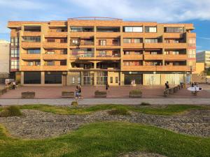 a large building with people walking in front of it at Mirador Canteras-Auditorio in Las Palmas de Gran Canaria