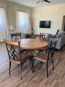 a living room with a wooden table and chairs at Kaye Devo in Choiseul