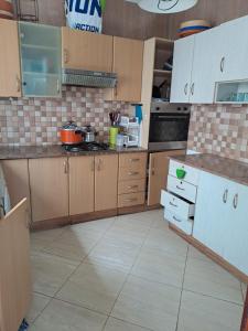 a kitchen with wooden cabinets and a tiled floor at Villa de rêves in Casablanca