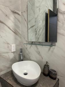 a bathroom with a white sink and a mirror at Caribbean Queen in Cancún