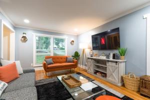 a living room with a couch and a table at NEW! Modern Luxury w/ Pool Table 3BR/5BD Sleeps 10 in Decatur