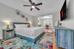 a bedroom with a bed and a ceiling fan at NEW! Modern Luxury w/ Pool Table 3BR/5BD Sleeps 10 in Decatur