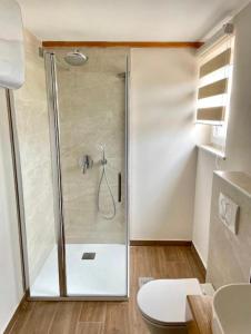 a shower with a glass door in a bathroom at Apartment Araucaria Gallery in Crikvenica +12 photos
