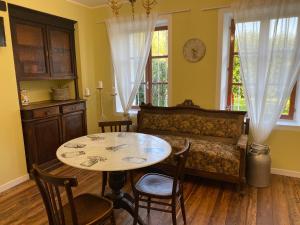 a room with a table and a bed and a table and chairs at Cascina Vica Biella in Andorno Micca