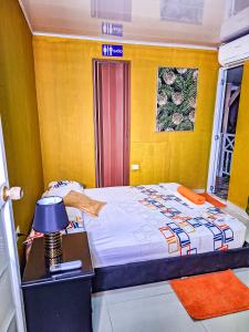 a bedroom with a bed and a table with a lamp at Posada Hostel Adri in Providencia