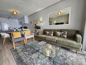 a living room with a couch and a table at Brookes Hill Suites Luxury Apartment 124 in Port Elizabeth